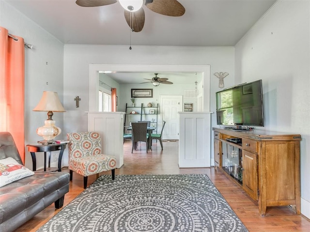 living room with a ceiling fan and light wood-style floors