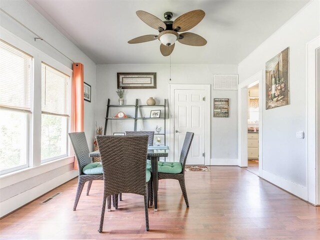 dining room featuring ceiling fan, wood finished floors, and baseboards
