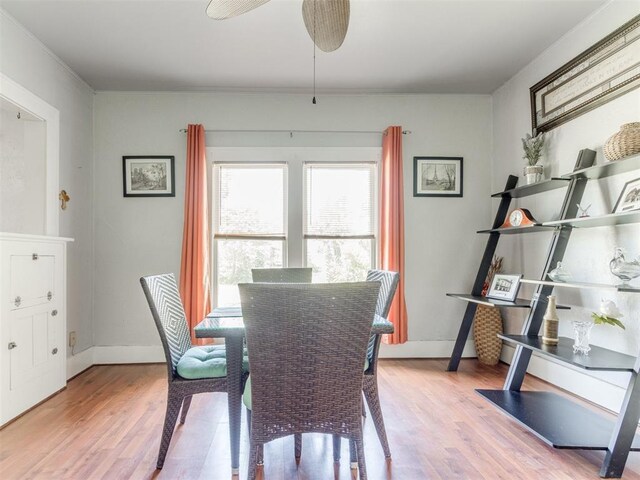 dining area featuring wood finished floors, baseboards, and a ceiling fan
