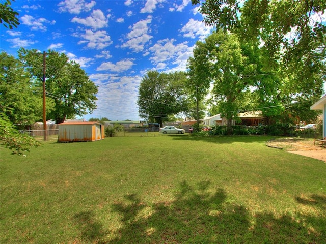 view of yard featuring a storage shed and an outdoor structure