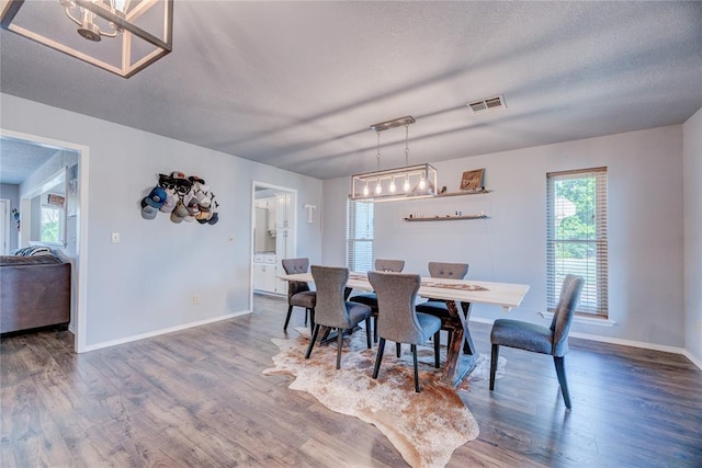 16070 N County Road 3264, Pauls Valley, OK 73075 - dining area featuring wood finished floors, baseboards, and a chandelier