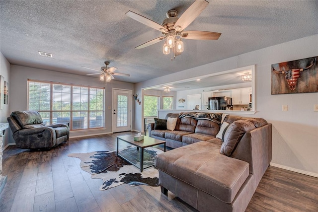 16070 N County Road 3264, Pauls Valley, OK 73075 - living area with a textured ceiling, ceiling fan, hardwood / wood-style floors, and baseboards