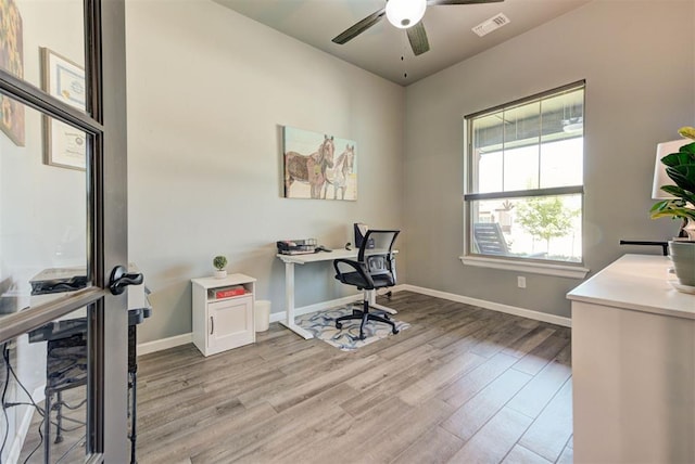 8624 Grey Wind Way, Arcadia, OK 73007 - home office with light wood-style floors, ceiling fan, and baseboards