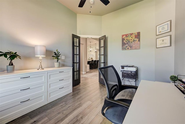 8624 Grey Wind Way, Arcadia, OK 73007 - home office with ceiling fan, light wood-style floors, and a chandelier
