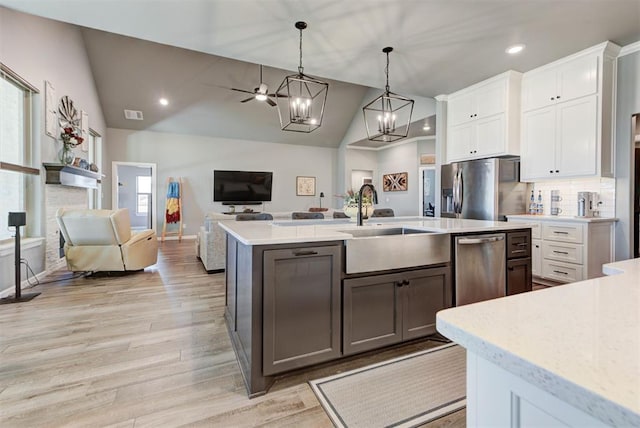 8624 Grey Wind Way, Arcadia, OK 73007 - kitchen featuring stainless steel refrigerator with ice dispenser, a sink, vaulted ceiling, recessed lighting, and white cabinets