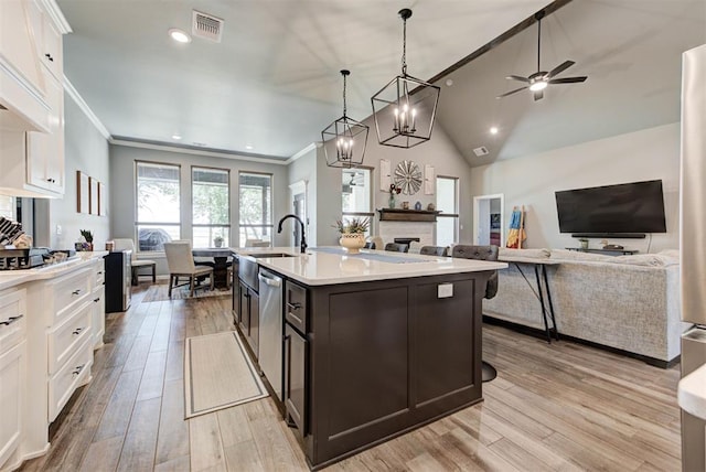 8624 Grey Wind Way, Arcadia, OK 73007 - kitchen with white cabinets, stainless steel dishwasher, light countertops, light wood-style flooring, and recessed lighting
