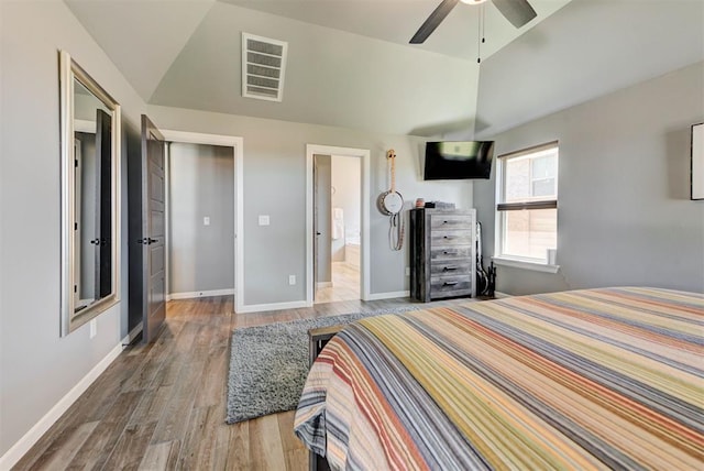 8624 Grey Wind Way, Arcadia, OK 73007 - bedroom with vaulted ceiling, wood finished floors, baseboards, ensuite bathroom, and ceiling fan
