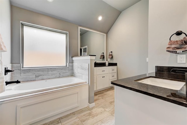 8624 Grey Wind Way, Arcadia, OK 73007 - bathroom with vanity, a bath, lofted ceiling, and recessed lighting