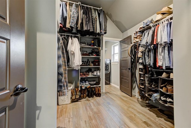 8624 Grey Wind Way, Arcadia, OK 73007 - spacious closet featuring wood finished floors, vaulted ceiling, and washer / clothes dryer