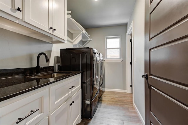 8624 Grey Wind Way, Arcadia, OK 73007 - laundry room with independent washer and dryer, baseboards, light wood-style flooring, and cabinet space