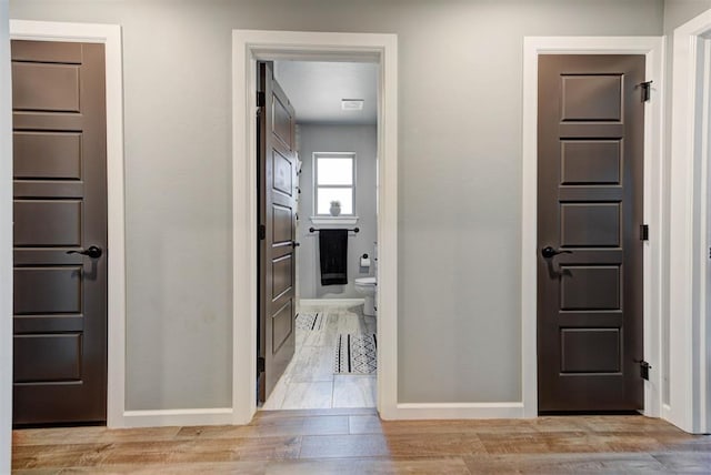 8624 Grey Wind Way, Arcadia, OK 73007 - hallway with baseboards and light wood-style floors