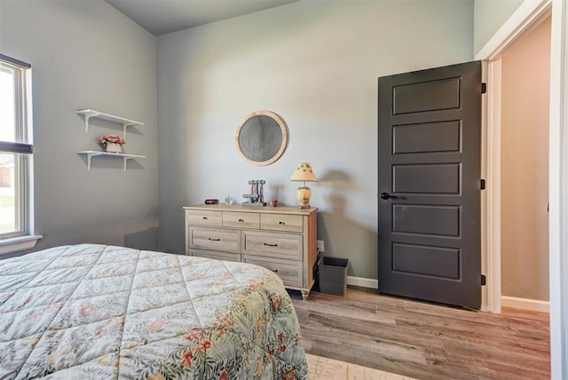 8624 Grey Wind Way, Arcadia, OK 73007 - bedroom with wood finished floors, multiple windows, and baseboards