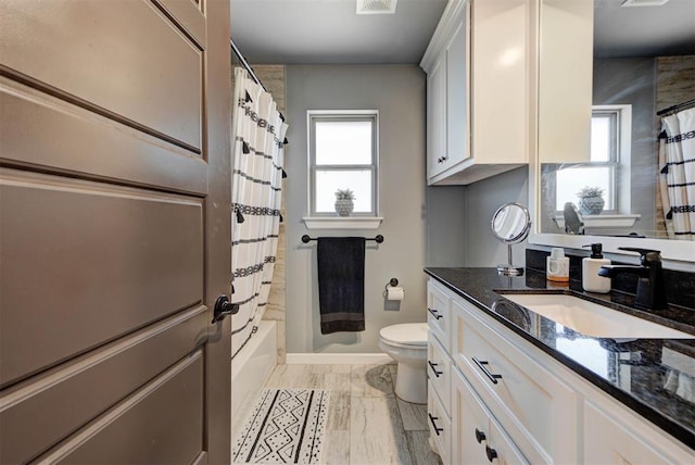 8624 Grey Wind Way, Arcadia, OK 73007 - bathroom featuring toilet, vanity, baseboards, shower / tub combo with curtain, and marble look tiles