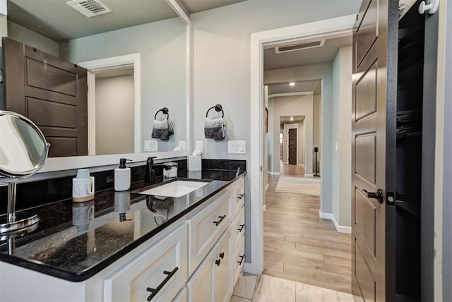 8624 Grey Wind Way, Arcadia, OK 73007 - bathroom featuring vanity, wood finished floors, and baseboards