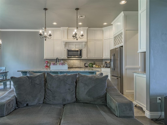 2145 Sycamore Creek Ave, Yukon, OK 73099 - kitchen featuring stainless steel appliances, a chandelier, recessed lighting, white cabinets, and crown molding