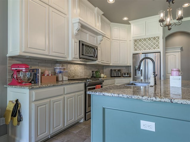 2145 Sycamore Creek Ave, Yukon, OK 73099 - kitchen featuring stainless steel appliances, a sink, white cabinetry, tasteful backsplash, and recessed lighting