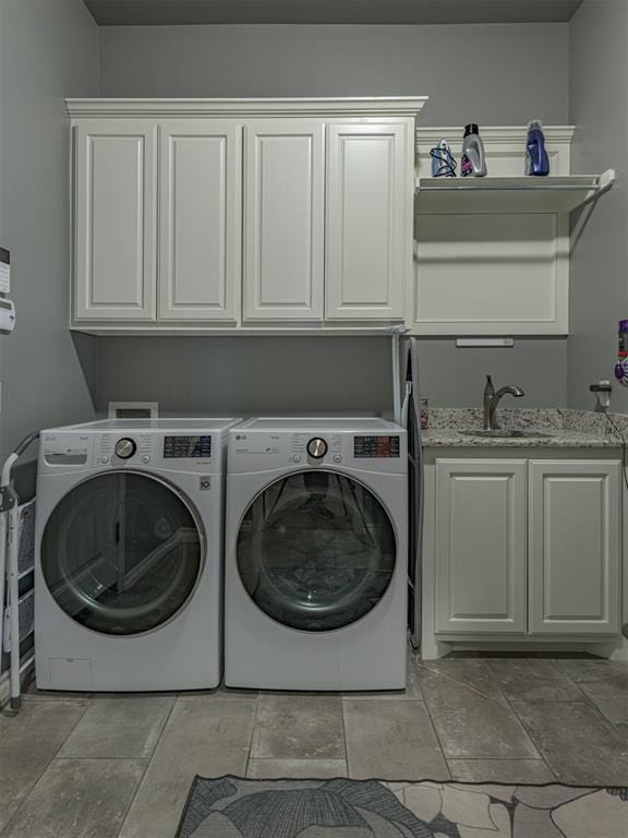 2145 Sycamore Creek Ave, Yukon, OK 73099 - laundry room featuring cabinet space, washer and clothes dryer, and stone tile flooring