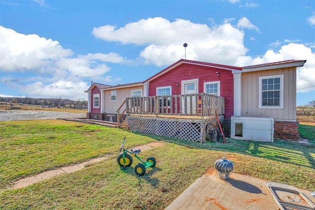 20930 E 1060th Rd, Canute, OK 73626 - rear view of property featuring a deck, a yard, and board and batten siding