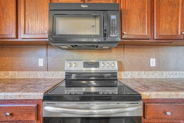 20930 E 1060th Rd, Canute, OK 73626 - kitchen featuring black microwave, stainless steel electric range, backsplash, and brown cabinetry