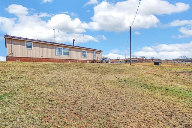 20930 E 1060th Rd, Canute, OK 73626 - back of property with crawl space, a lawn, and metal roof