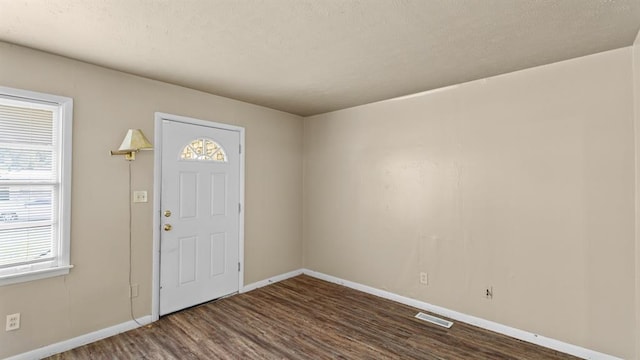 4313 SE 13th St, Oklahoma City, OK 73115 - foyer entrance featuring dark wood-style floors, plenty of natural light, and baseboards