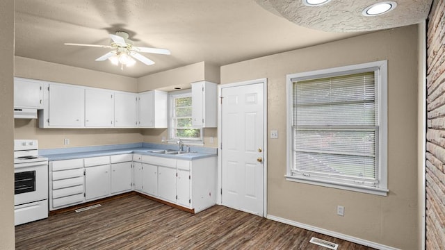 4313 SE 13th St, Oklahoma City, OK 73115 - kitchen with electric stove, a sink, exhaust hood, white cabinetry, and ceiling fan