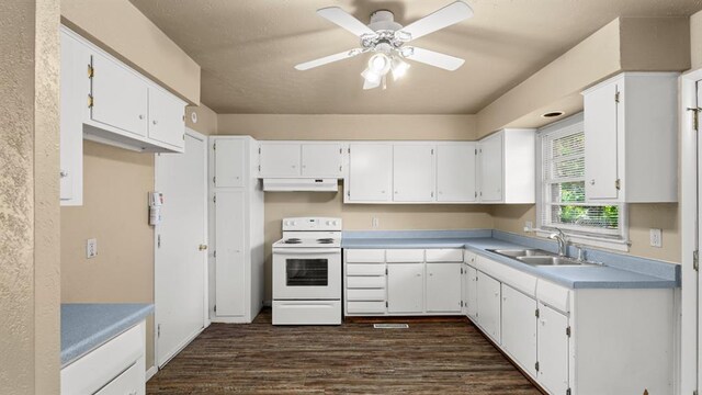 4313 SE 13th St, Oklahoma City, OK 73115 - kitchen featuring white range with electric cooktop, under cabinet range hood, a sink, dark wood-type flooring, and white cabinetry