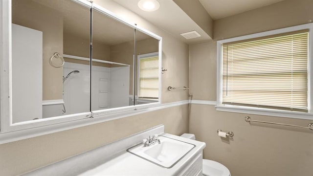 4313 SE 13th St, Oklahoma City, OK 73115 - bathroom featuring toilet, vanity, and a shower