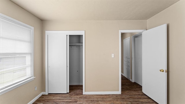 4313 SE 13th St, Oklahoma City, OK 73115 - unfurnished bedroom featuring dark wood-style floors, a closet, and baseboards
