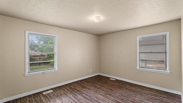 4313 SE 13th St, Oklahoma City, OK 73115 - empty room with dark wood finished floors, baseboards, and a textured ceiling