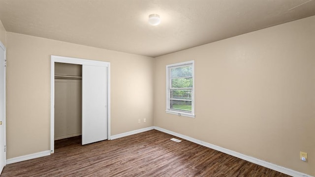 4313 SE 13th St, Oklahoma City, OK 73115 - unfurnished bedroom featuring dark wood finished floors, baseboards, and a closet