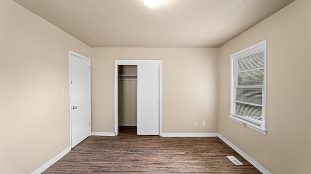 4313 SE 13th St, Oklahoma City, OK 73115 - unfurnished bedroom with dark wood-style flooring, a closet, and baseboards