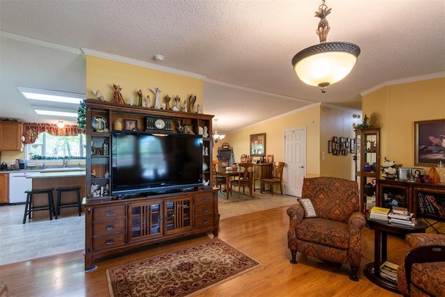 13351 El Zorro, Edmond, OK 73034 - living area featuring crown molding, light wood-style flooring, a chandelier, and a textured ceiling