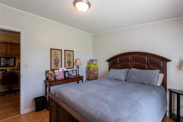 13351 El Zorro, Edmond, OK 73034 - bedroom featuring light wood-style flooring, crown molding, an office area, and a textured ceiling