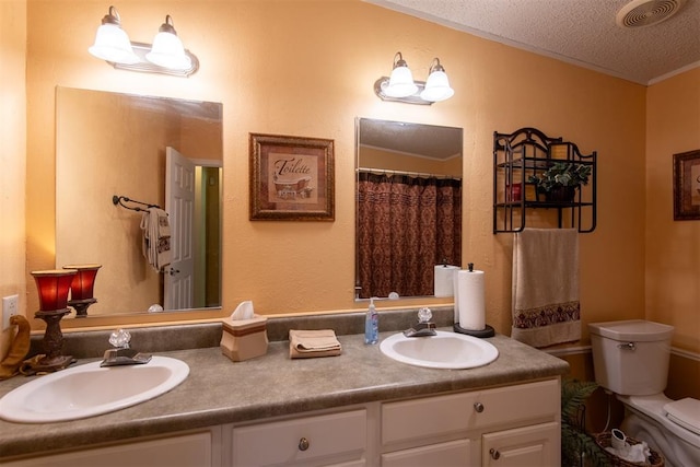 13351 El Zorro, Edmond, OK 73034 - bathroom featuring double vanity and a textured ceiling