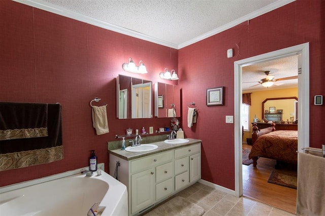 13351 El Zorro, Edmond, OK 73034 - bathroom featuring connected bathroom, a textured ceiling, a garden tub, double vanity, and crown molding
