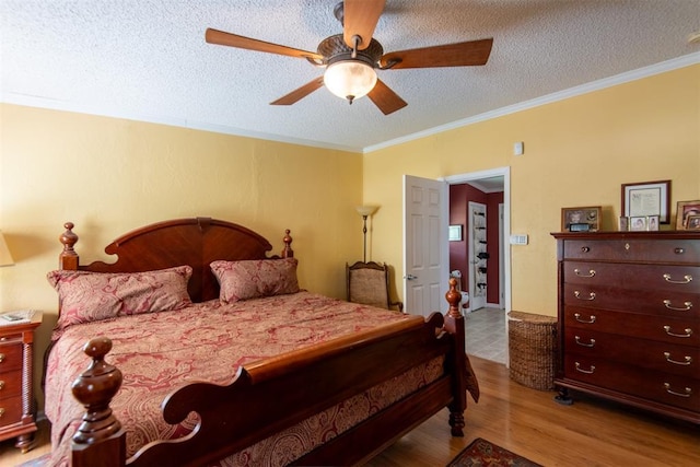 13351 El Zorro, Edmond, OK 73034 - bedroom with wood finished floors, a textured ceiling, crown molding, and ceiling fan
