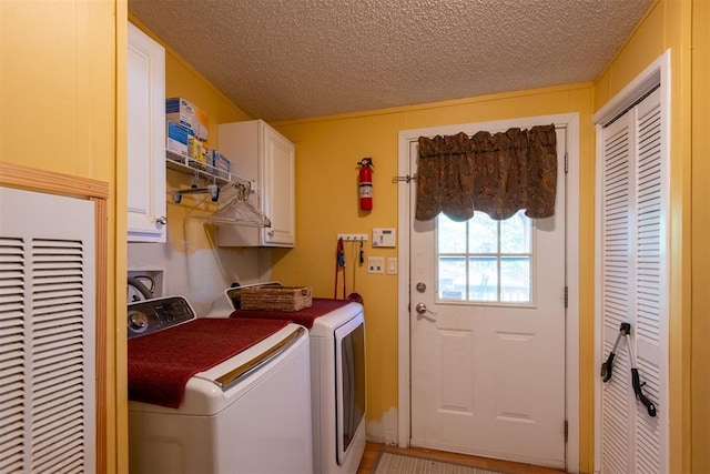 13351 El Zorro, Edmond, OK 73034 - laundry room with cabinet space, washer and dryer, a heating unit, and a textured ceiling