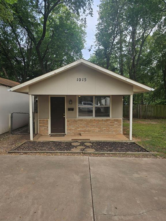 1015 W 10th Ave, Stillwater, OK 74074 - view of front of home featuring covered porch and brick siding