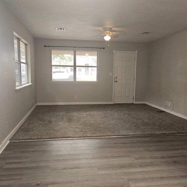1015 W 10th Ave, Stillwater, OK 74074 - empty room with ceiling fan, baseboards, and wood finished floors