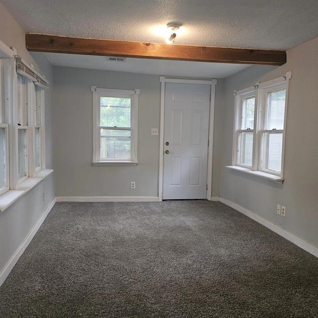 1015 W 10th Ave, Stillwater, OK 74074 - foyer with a textured ceiling, carpet flooring, beam ceiling, and baseboards