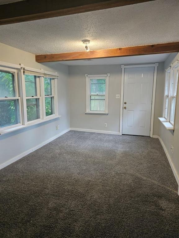 1015 W 10th Ave, Stillwater, OK 74074 - entrance foyer with carpet, baseboards, and a textured ceiling