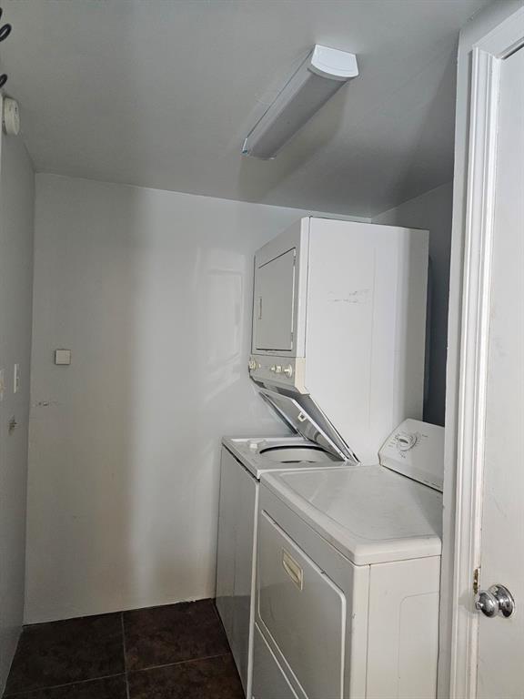1015 W 10th Ave, Stillwater, OK 74074 - clothes washing area with estacked washer and dryer