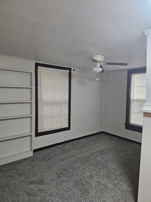 1015 W 10th Ave, Stillwater, OK 74074 - spare room featuring a ceiling fan and baseboards