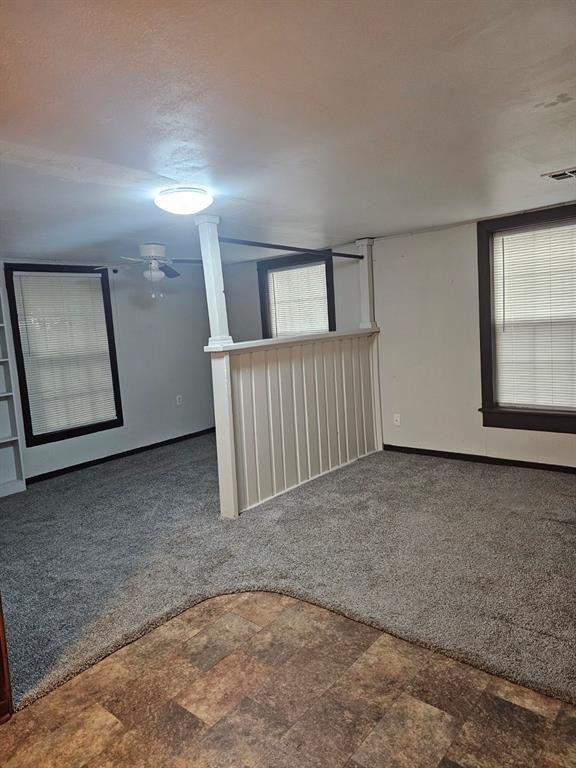 1015 W 10th Ave, Stillwater, OK 74074 - spare room with carpet floors and baseboards