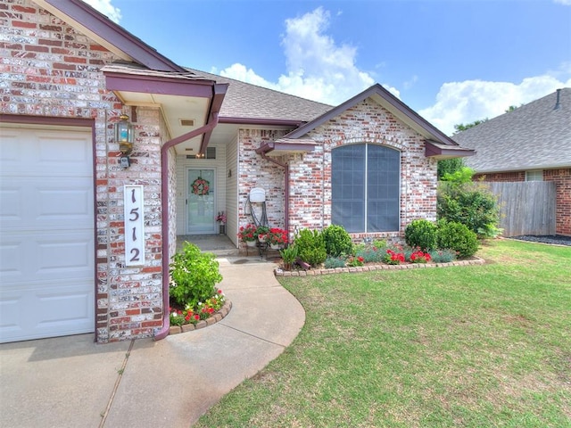 1512 Selborne Pl, Yukon, OK 73099 - view of exterior entry featuring an attached garage, brick siding, and roof with shingles