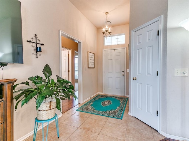 1512 Selborne Pl, Yukon, OK 73099 - entryway with a chandelier, light tile patterned flooring, and baseboards
