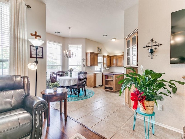 1512 Selborne Pl, Yukon, OK 73099 - living room featuring a chandelier, healthy amount of natural light, baseboards, and vaulted ceiling