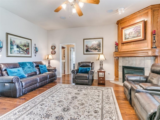 1512 Selborne Pl, Yukon, OK 73099 - living area featuring a ceiling fan, wood finished floors, a tile fireplace, and baseboards