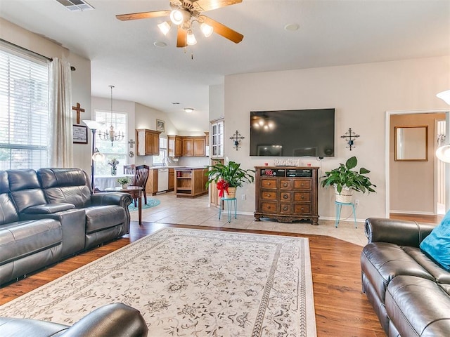 1512 Selborne Pl, Yukon, OK 73099 - living area with ceiling fan, light wood finished floors, baseboards, and a chandelier